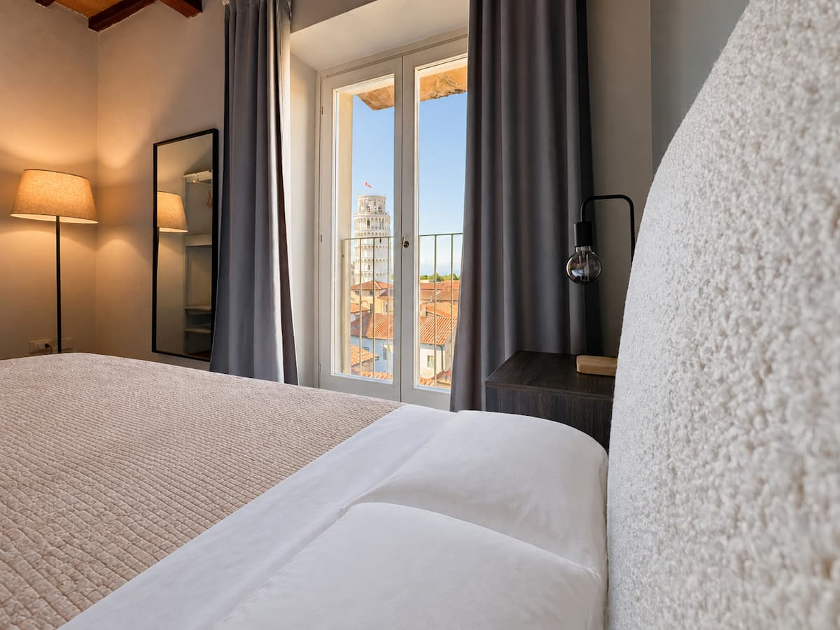 The Leaning Tower framed by the bedroom window in Granduca Tower Suite